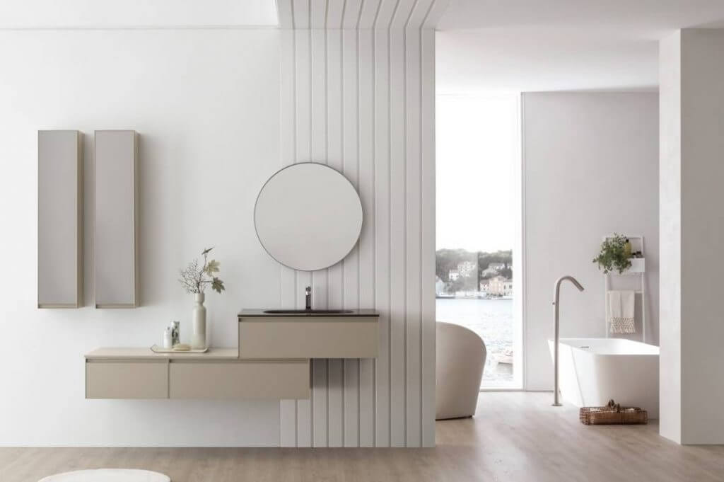 Arredare casa stile minimal: less is more! | Facile Ristrutturare bagno minimal con specchio rotorndo e lavabo a sospensione.