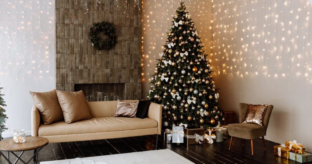 A ogni pavimento il suo albero di Natale! | Facile Ristrutturare Soggiorno con albero di Natale accanto a un divano beige e luci decorative.