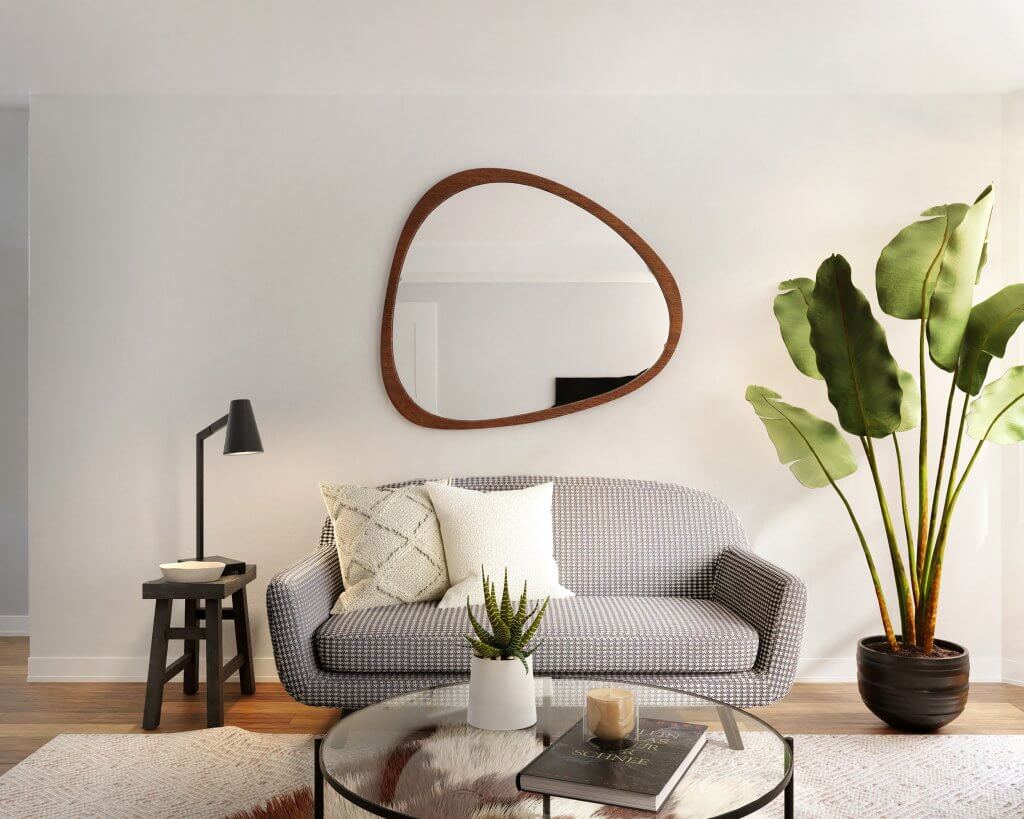 Arredare con gli specchi: consigli per dare luce e spazio agli ambienti di casa | Facile Ristrutturare Specchio nel soggiorno con divano e piante con tavolo in vetro